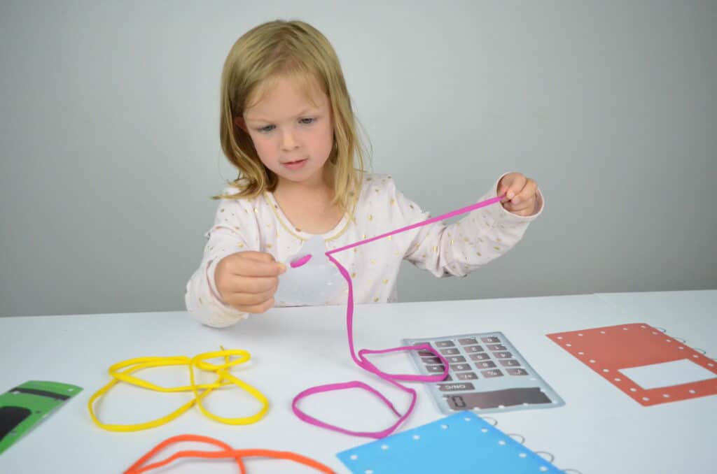 preschool girl lacing cards activity