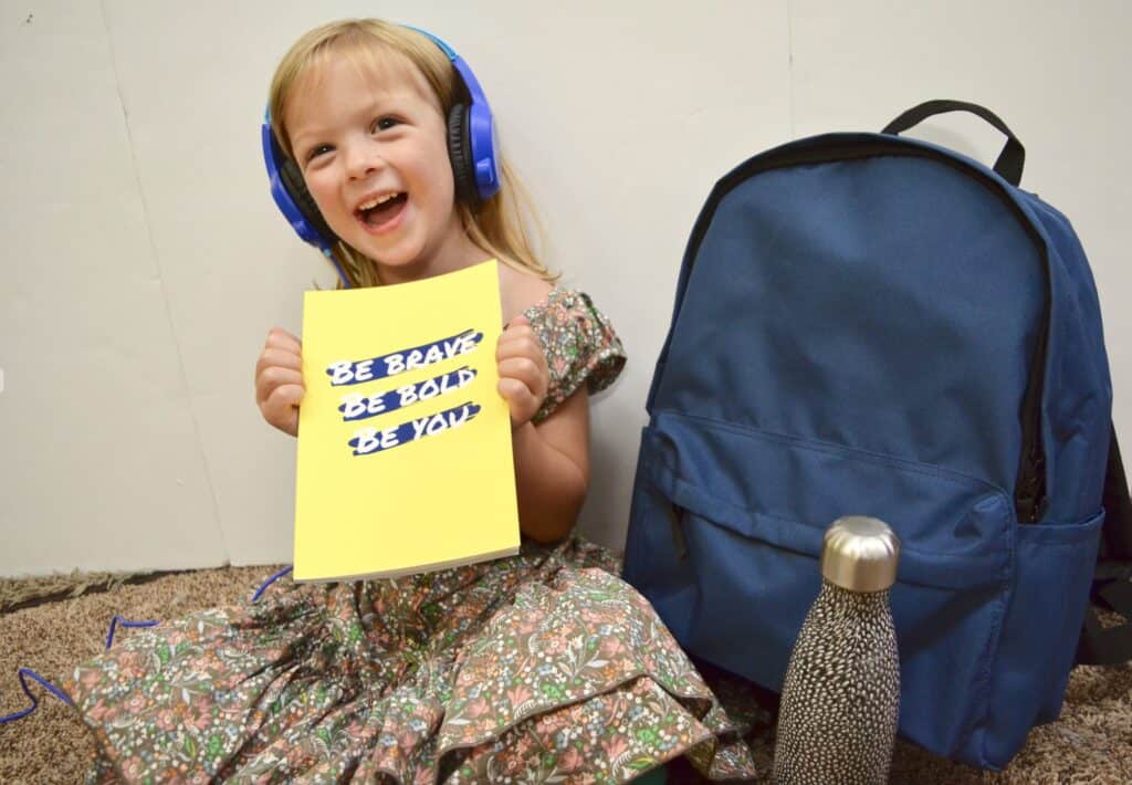 happy school year celebration preschool girl with headphones school supplies