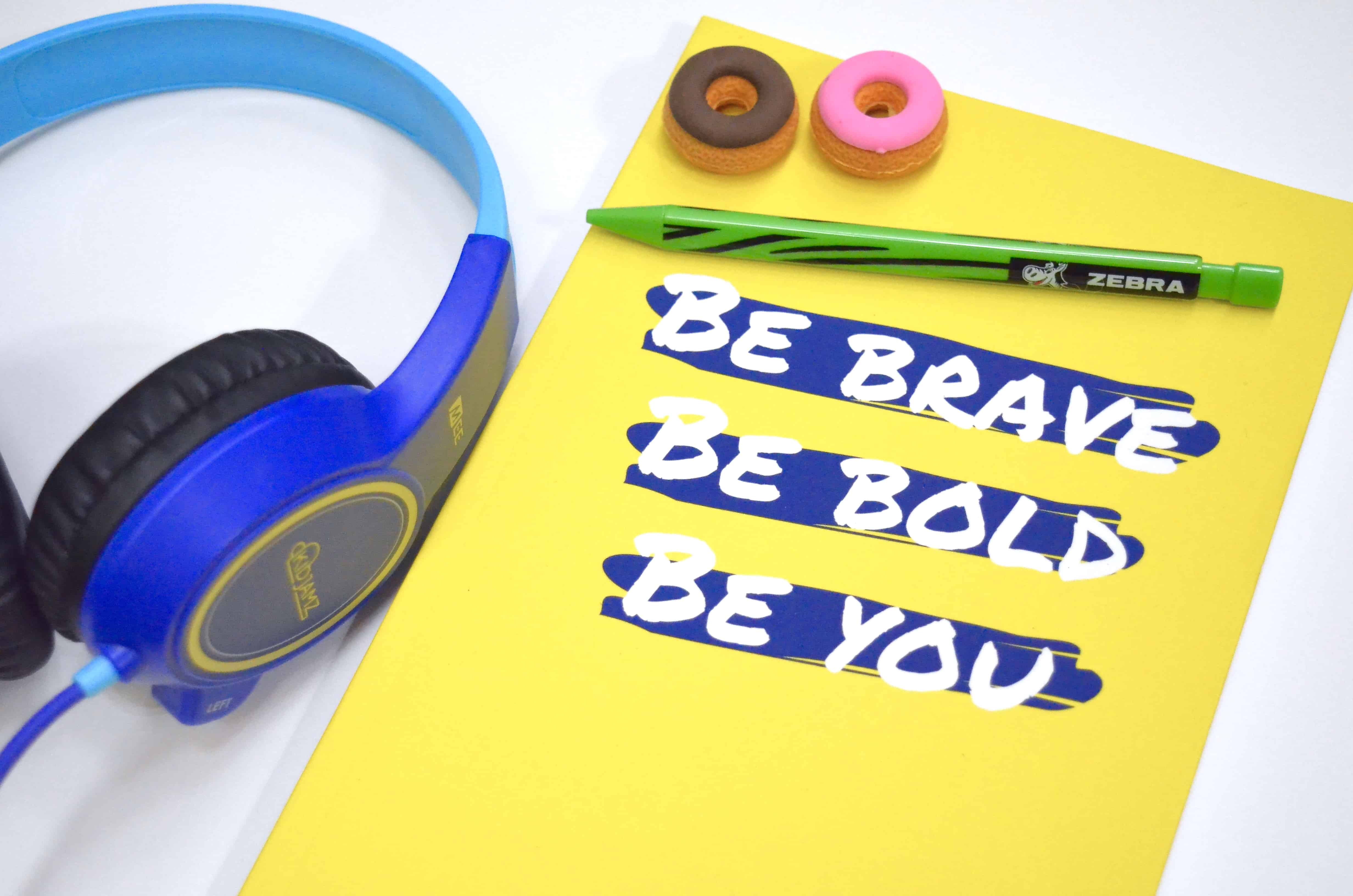 yellow inspirational notebook with headphones