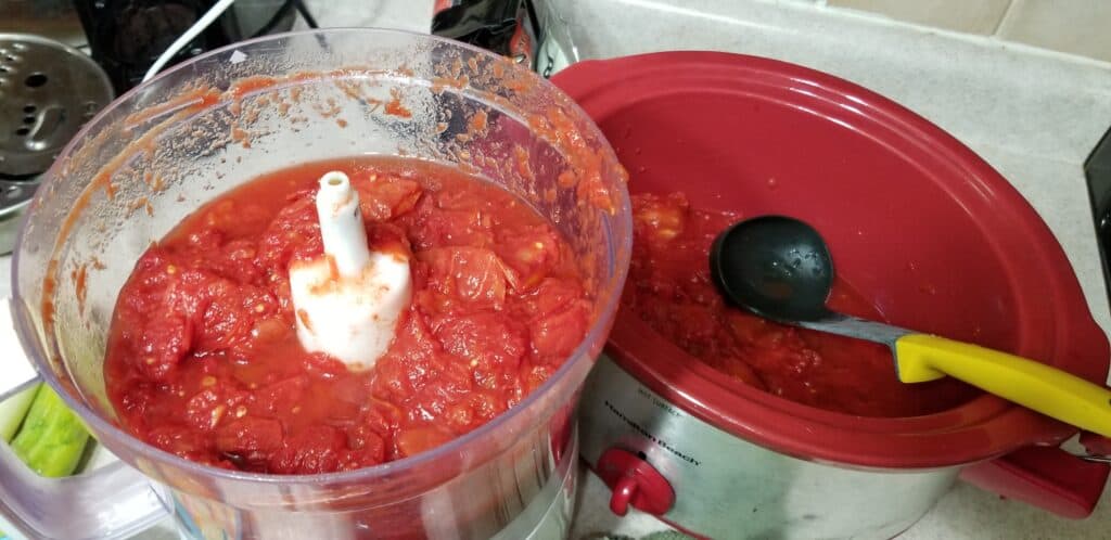 pureeing tomatoes in food processor