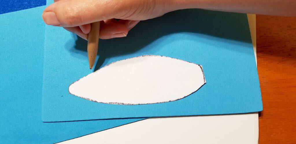 tracing white bunny ear on blue craft foam