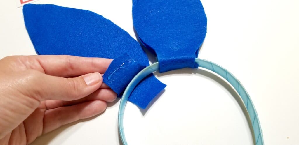 attaching blue bunny ears on headband