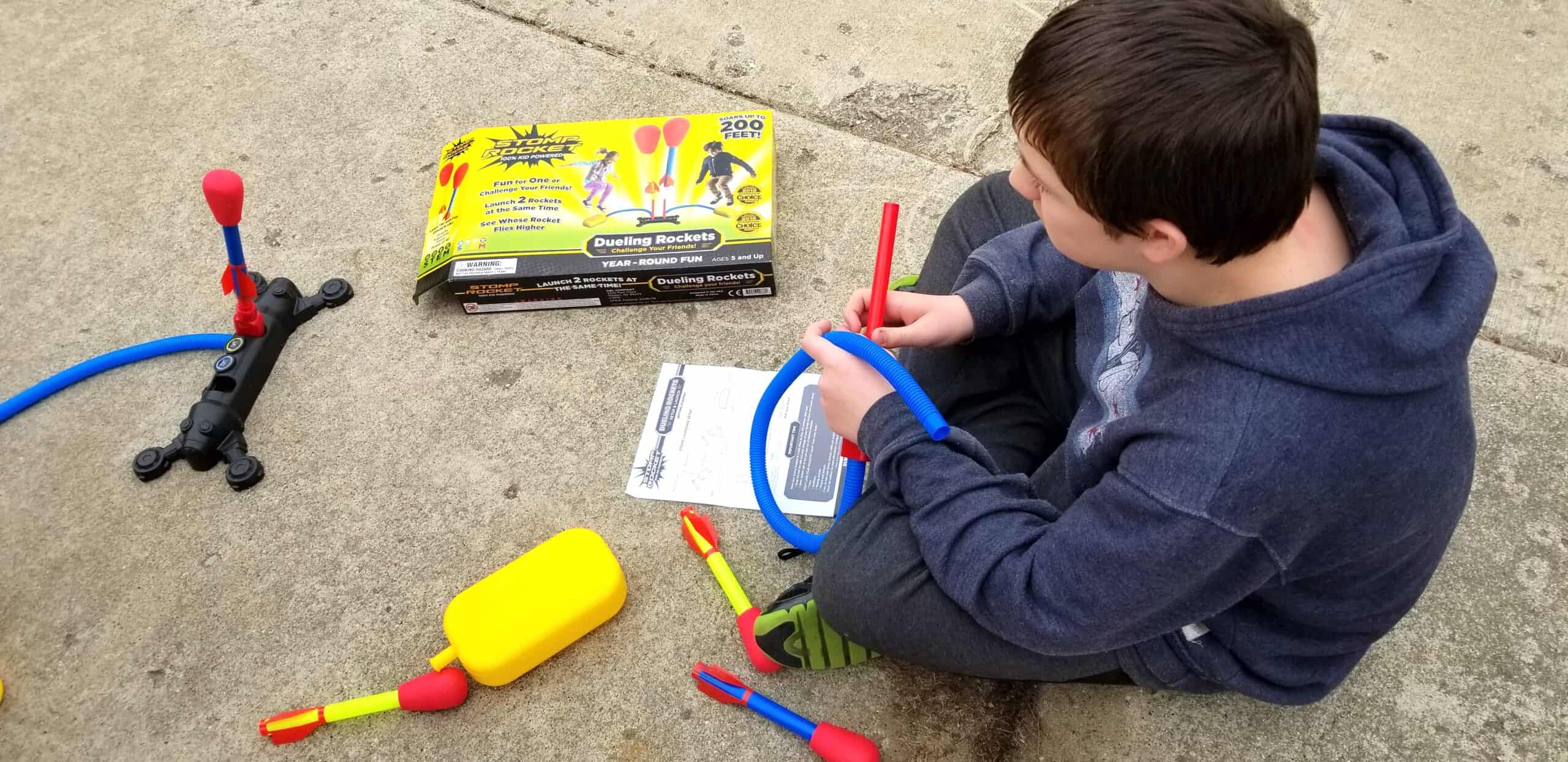 boy putting together stomp rockets kit