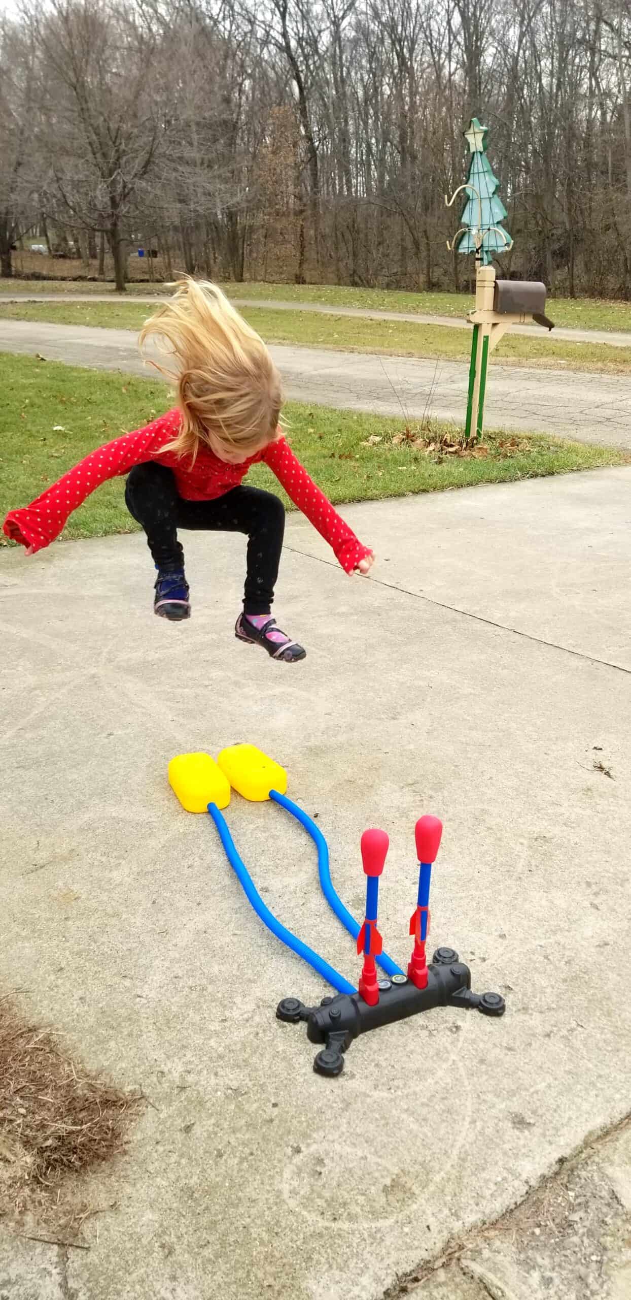 girl jumping on stomp rockets toy