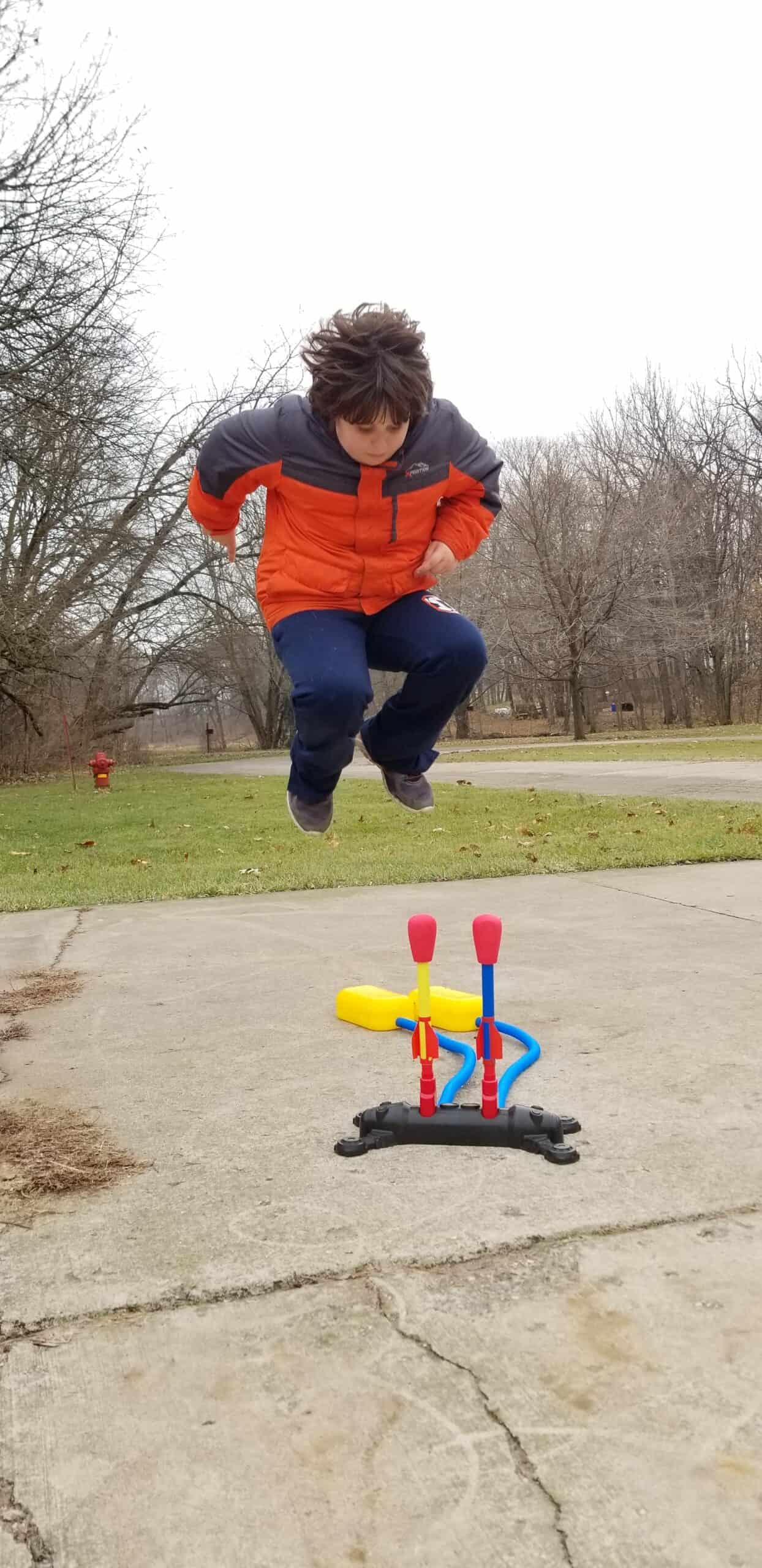 boy jumping on stomp rockets toy