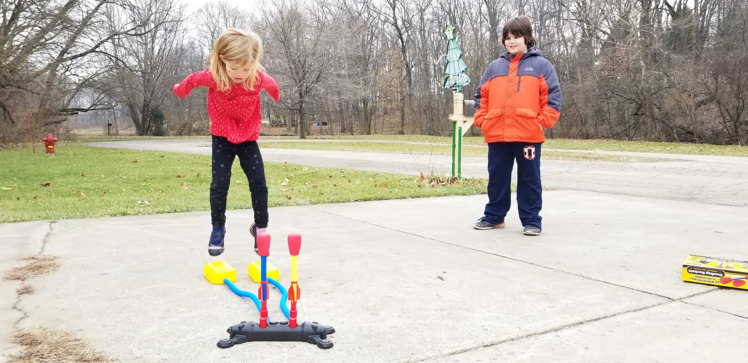 preschool girl jumping on rockets