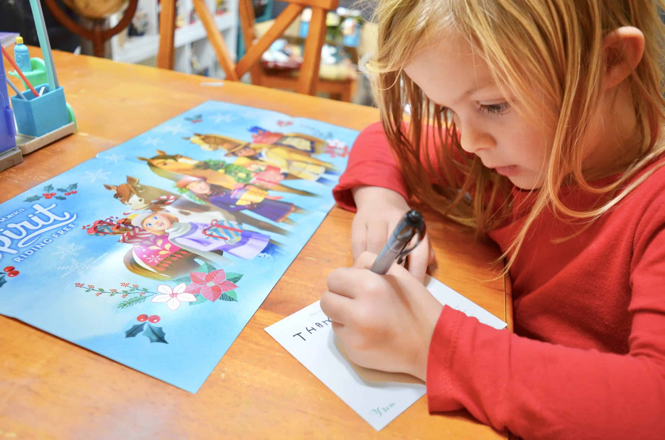 girl writing letter on a postcard