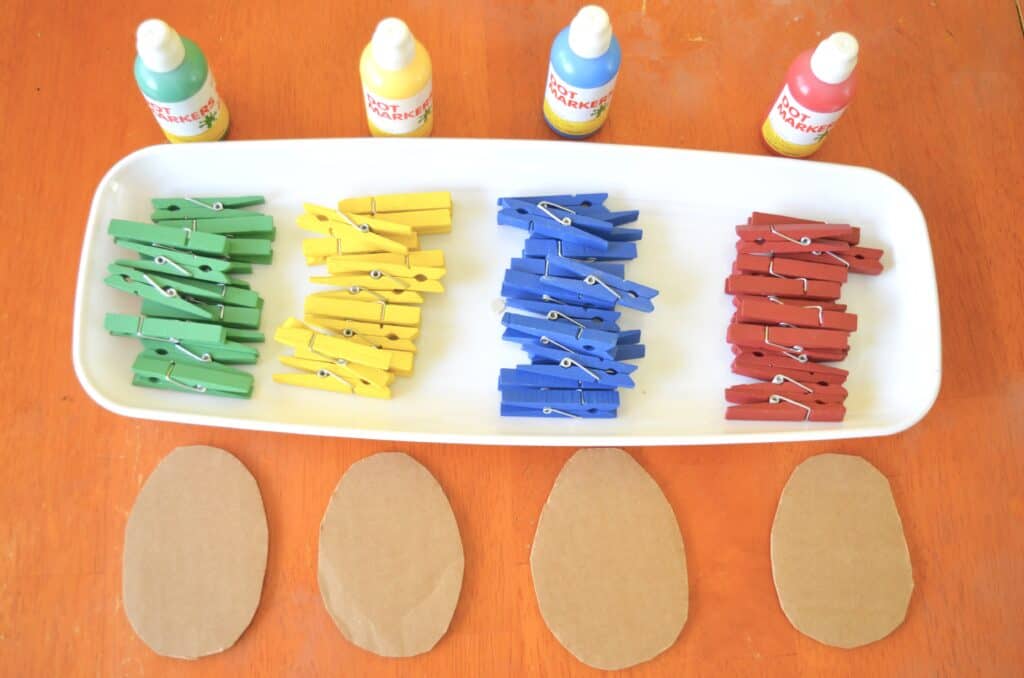 tray of colorful clothespins and paint