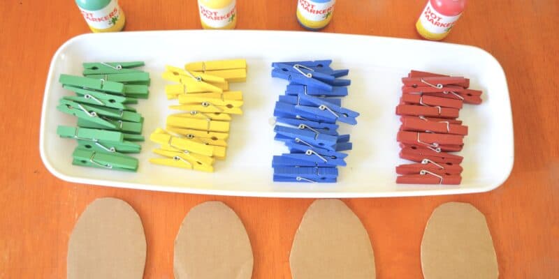 tray of colorful clothespins and paint