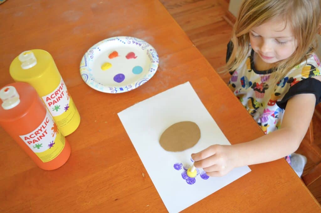 child painting with sponge