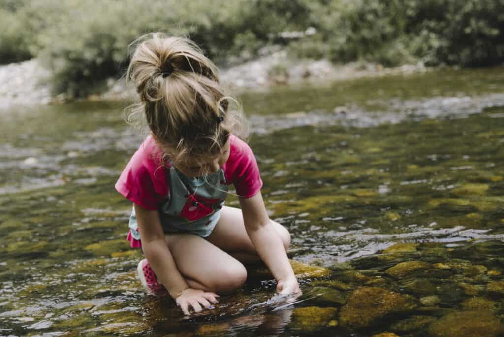 girl playing in lake water