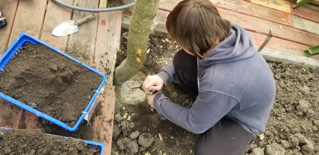 teen boy building digging