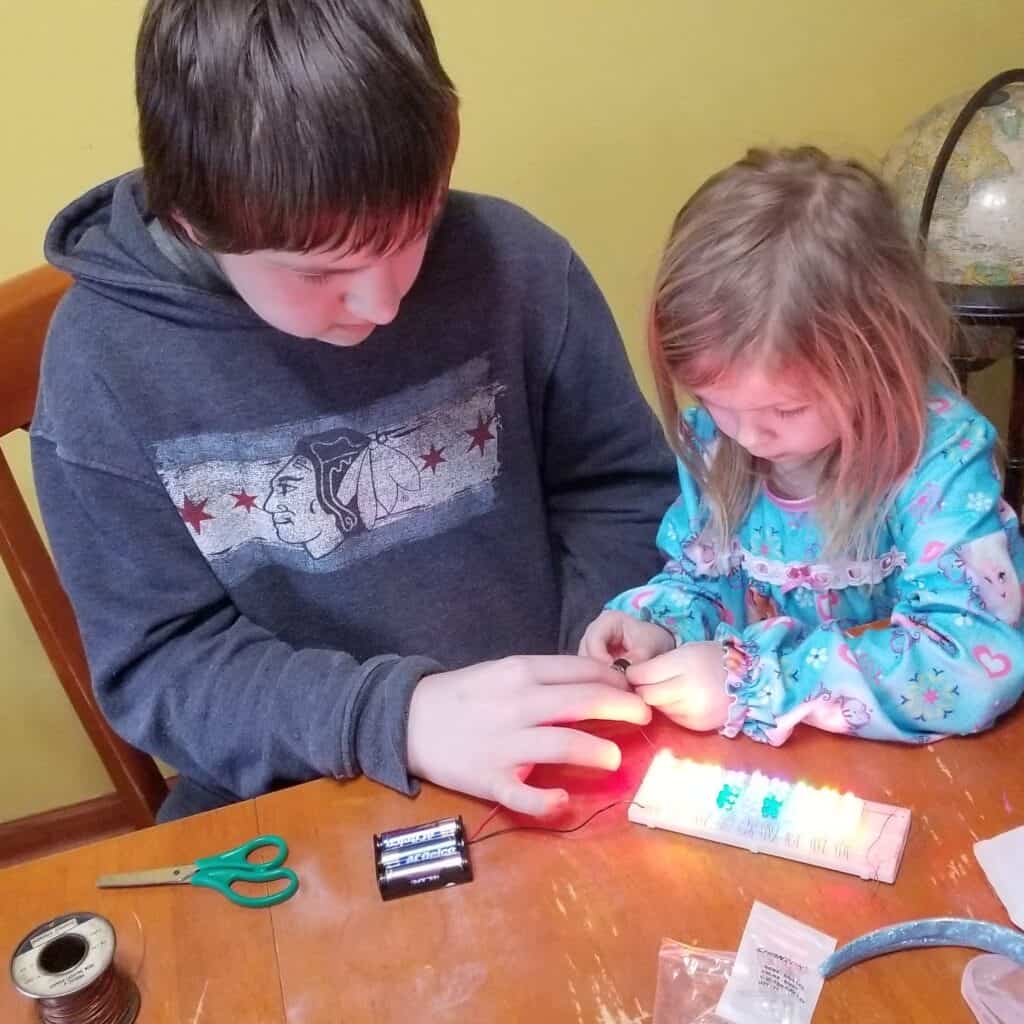 teen boy and preschool girl science experiment