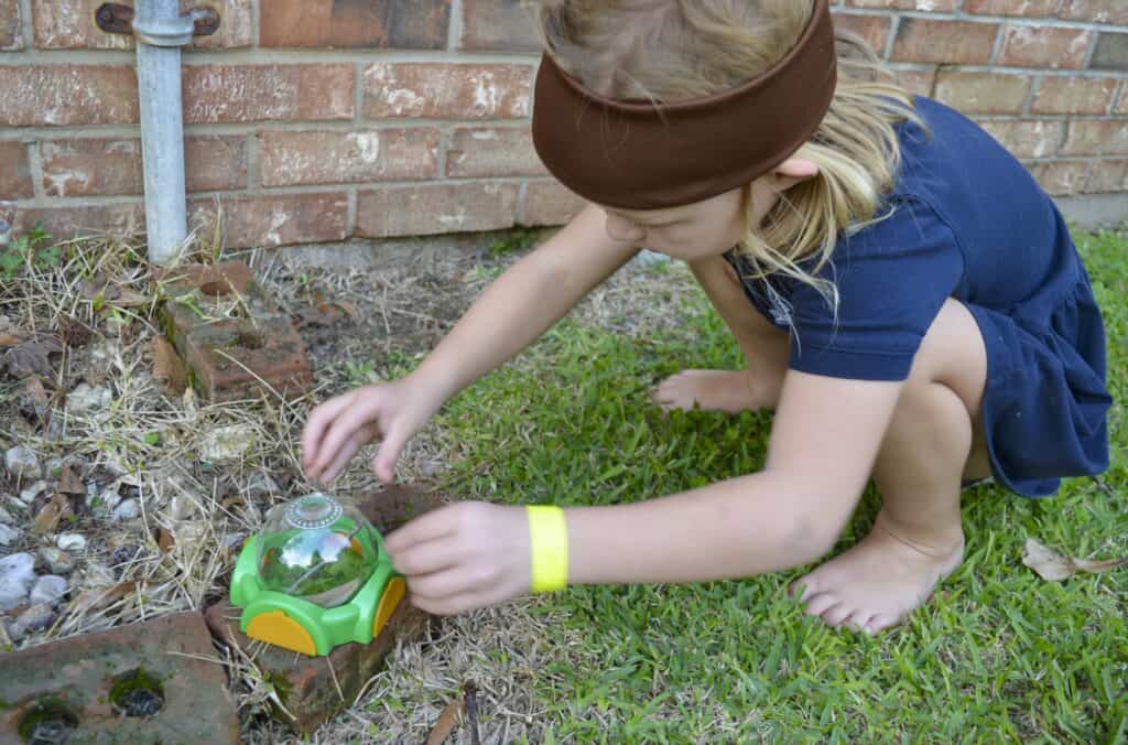 girl outside catching bug habitat