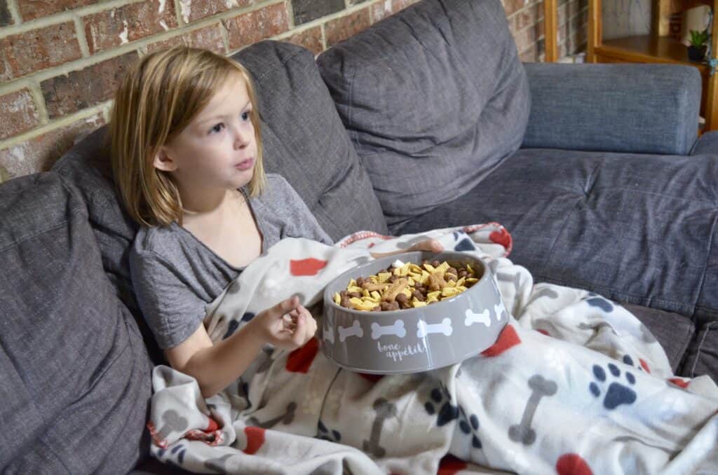 little girl eating puppy chow