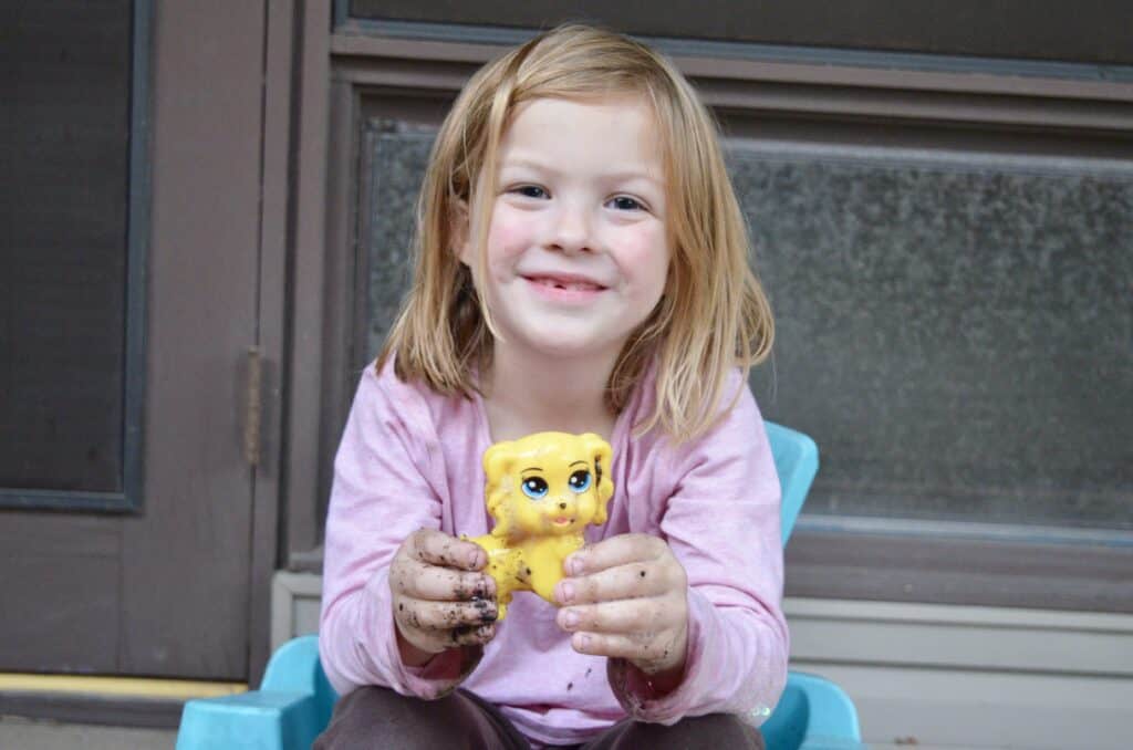 preschool girl holding dog toy