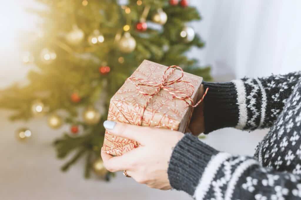 hands holding Christmas gift stock