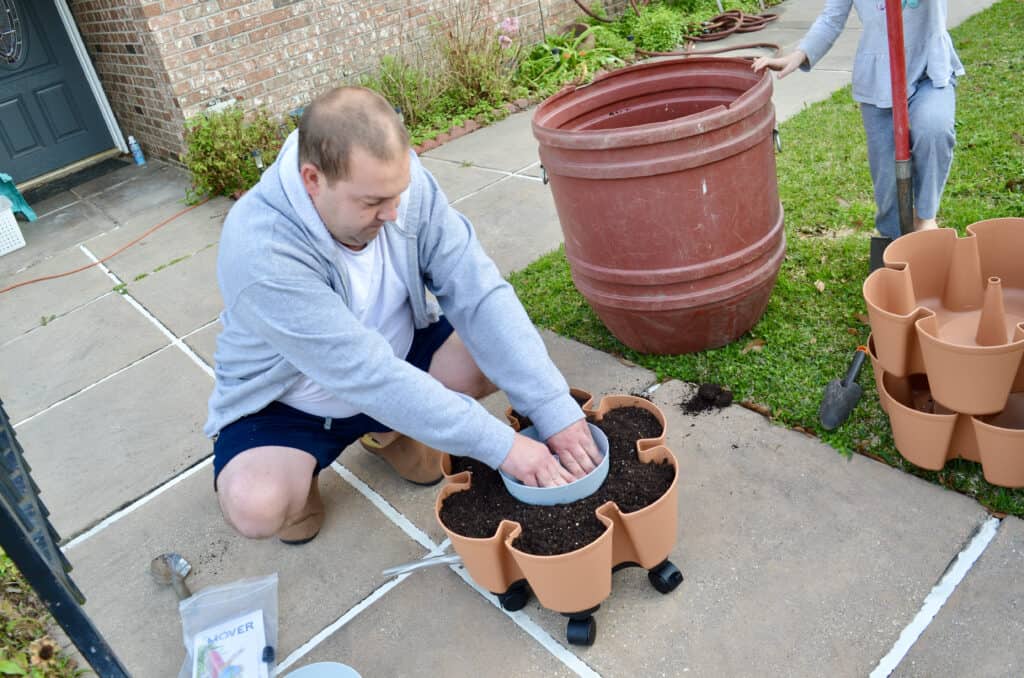 man putting together GreenStalk Vertical Garden