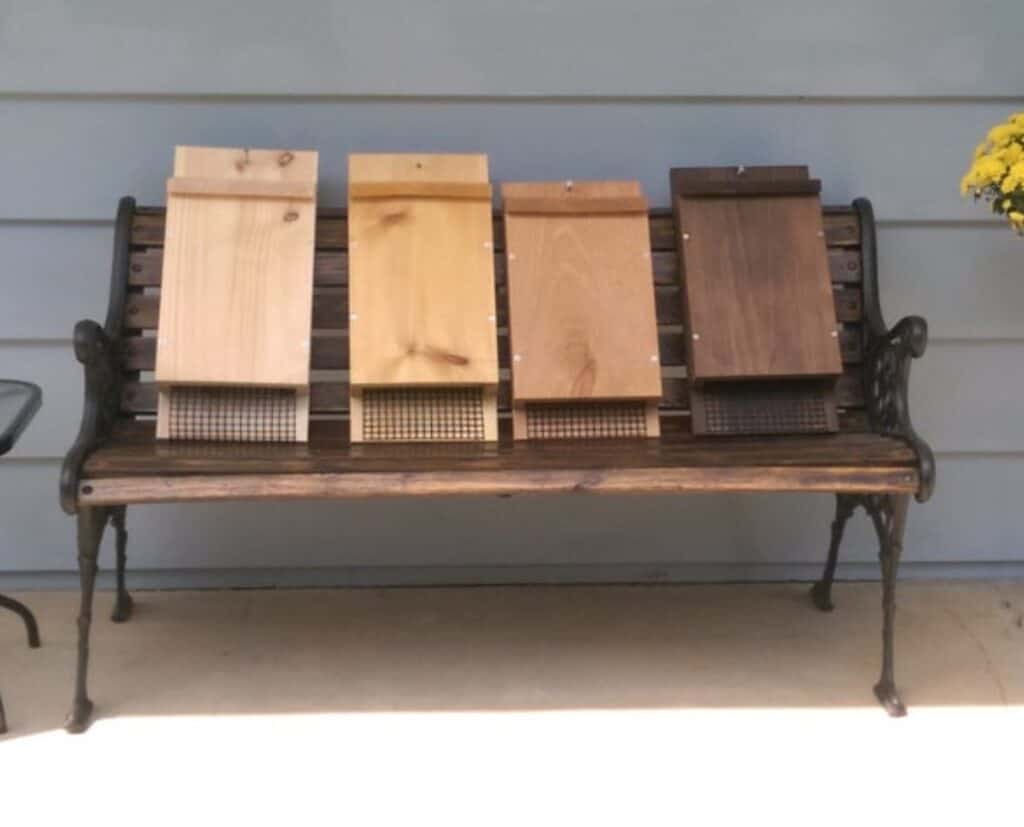 row of bat houses on a bench