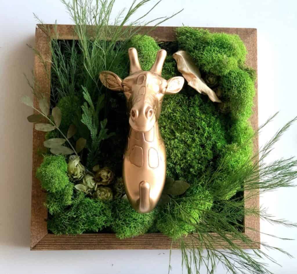 gold giraffe in green planter frame