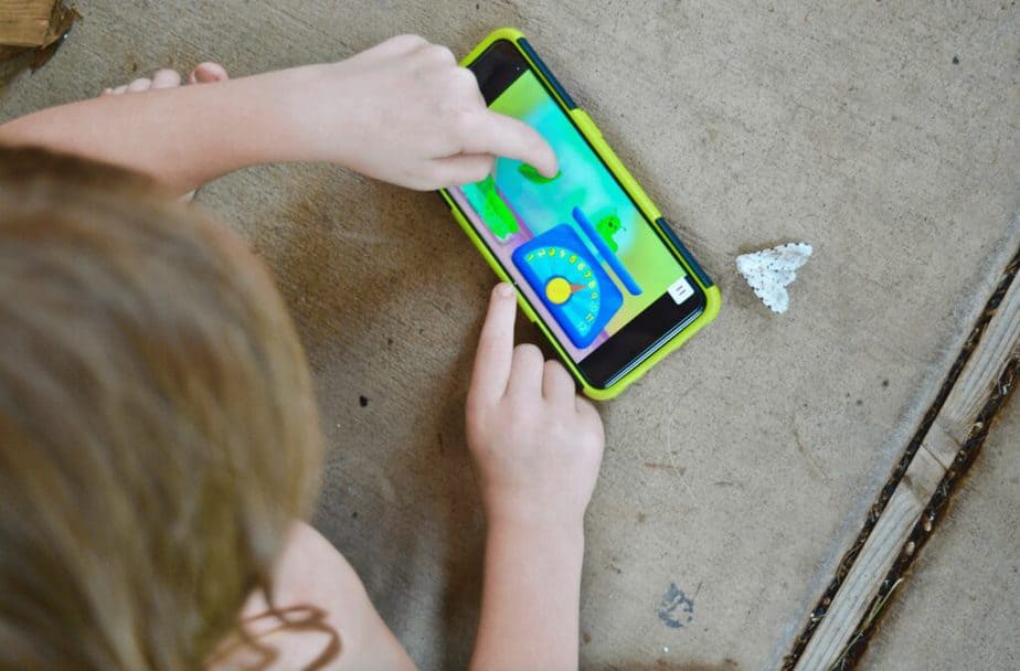 girl playing Noggin app outside