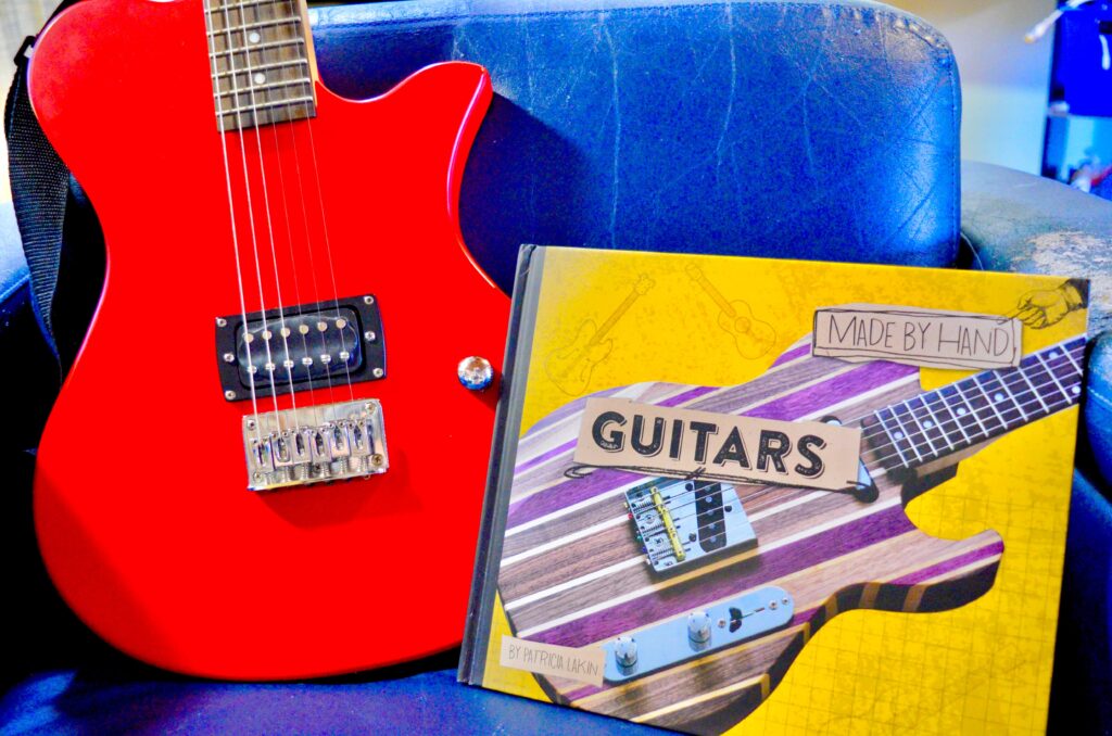 red electric guitar with Guitar book