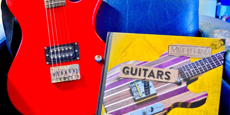 red electric guitar with Guitar book