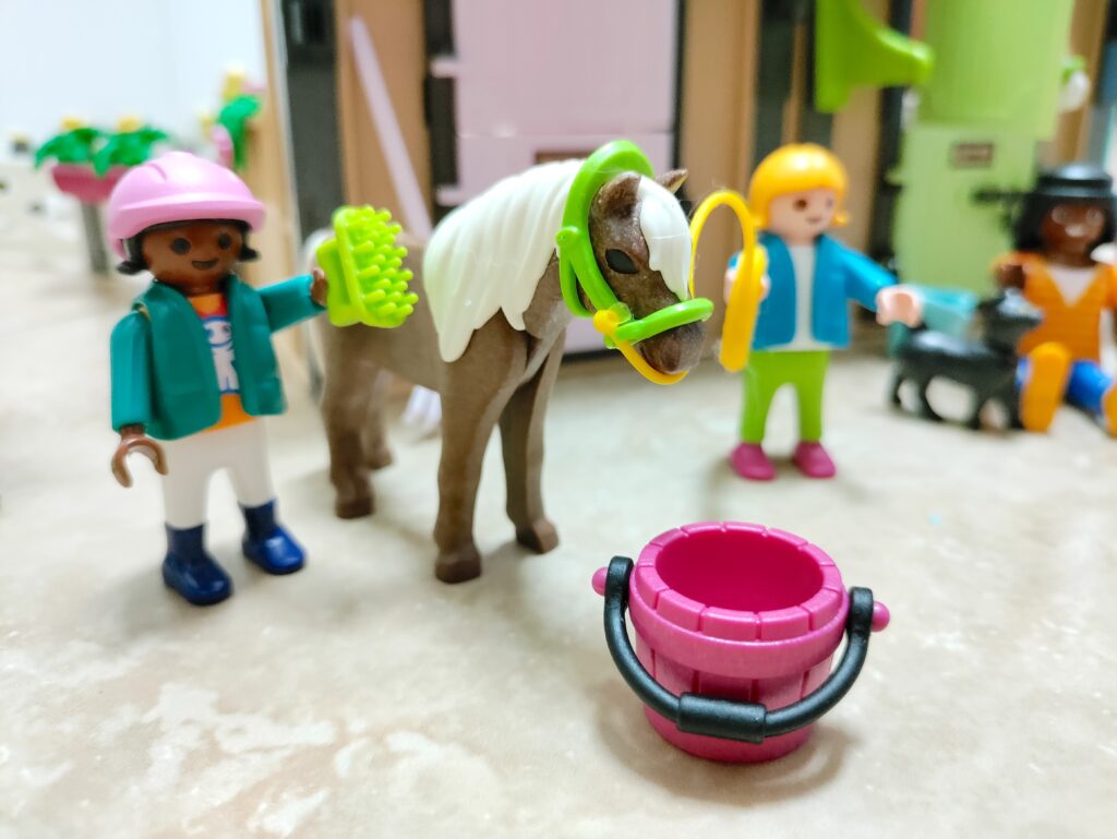 Playmobile toy kids with horse at stable