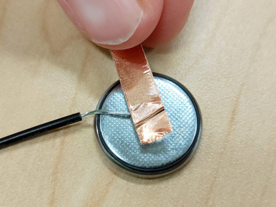 taping a wire on the negative side of a battery