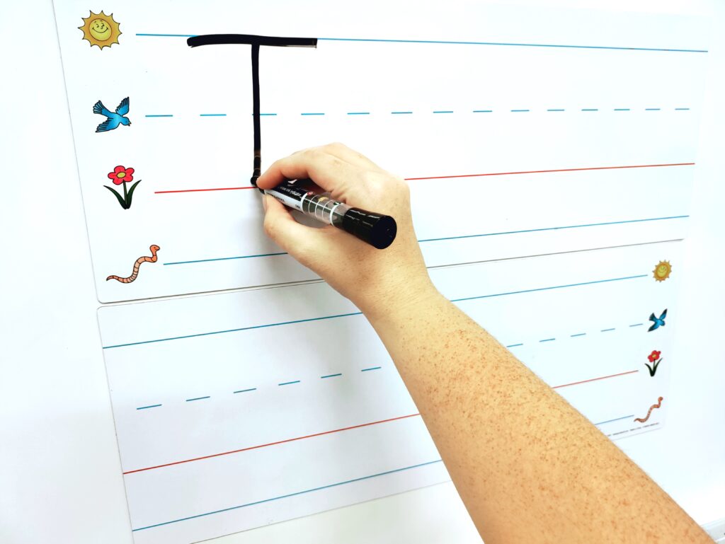 Writing the letter "T" on Jumbo Dry Erase Magnetic Writing Line Strips